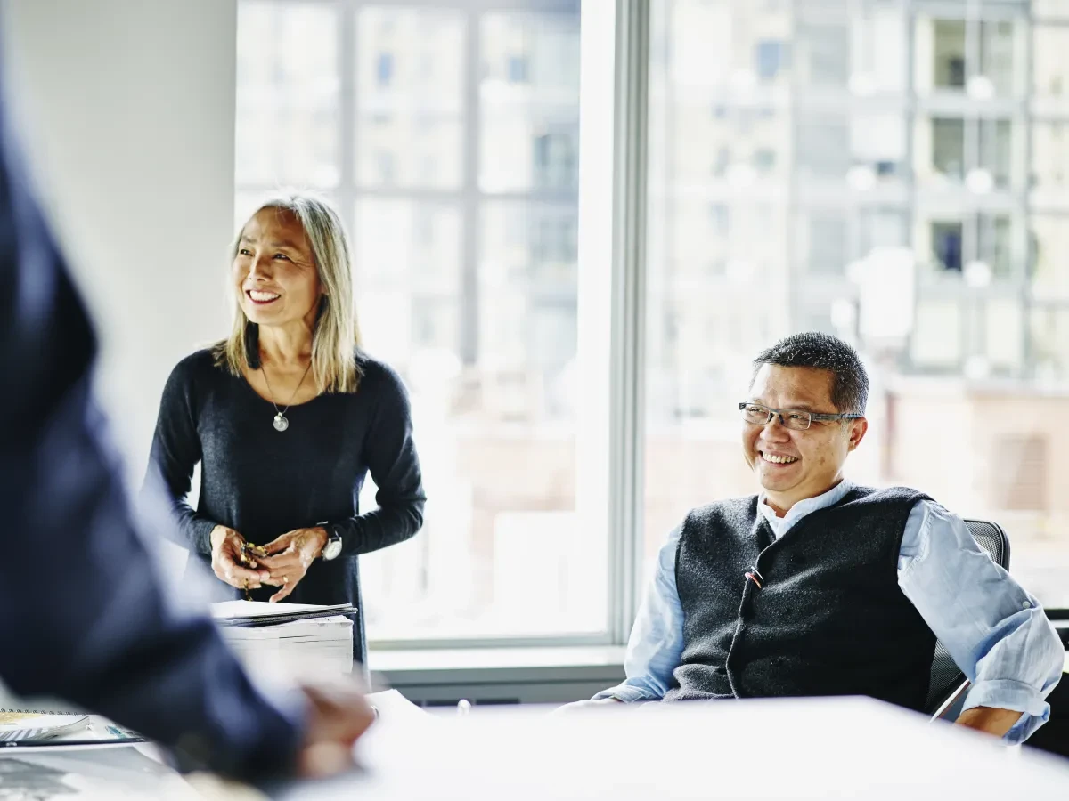 smiling mature architects laughing during meeting