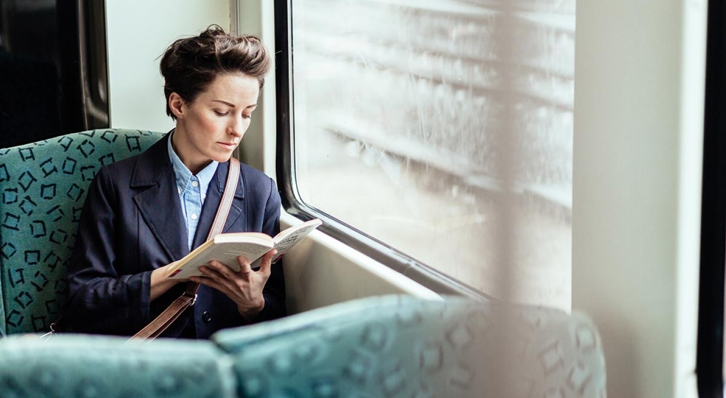 woman on train reading book