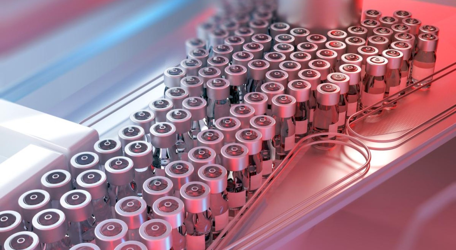 vaccine vials on assembly line with red and blue lights in background