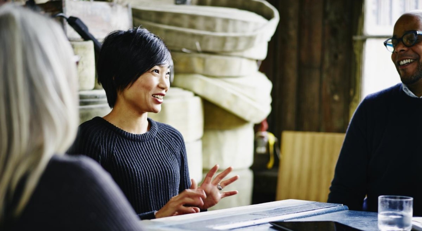 diverse group of three executives having conversation