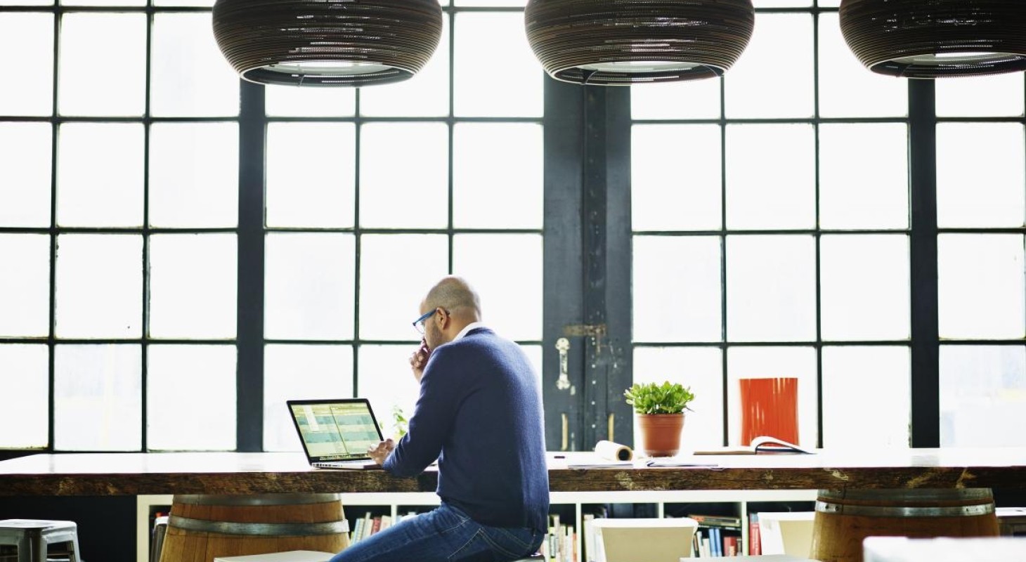 business owner in studio office working on spreadsheet