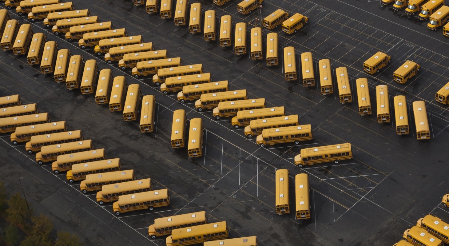 school buses in parking lot view from above