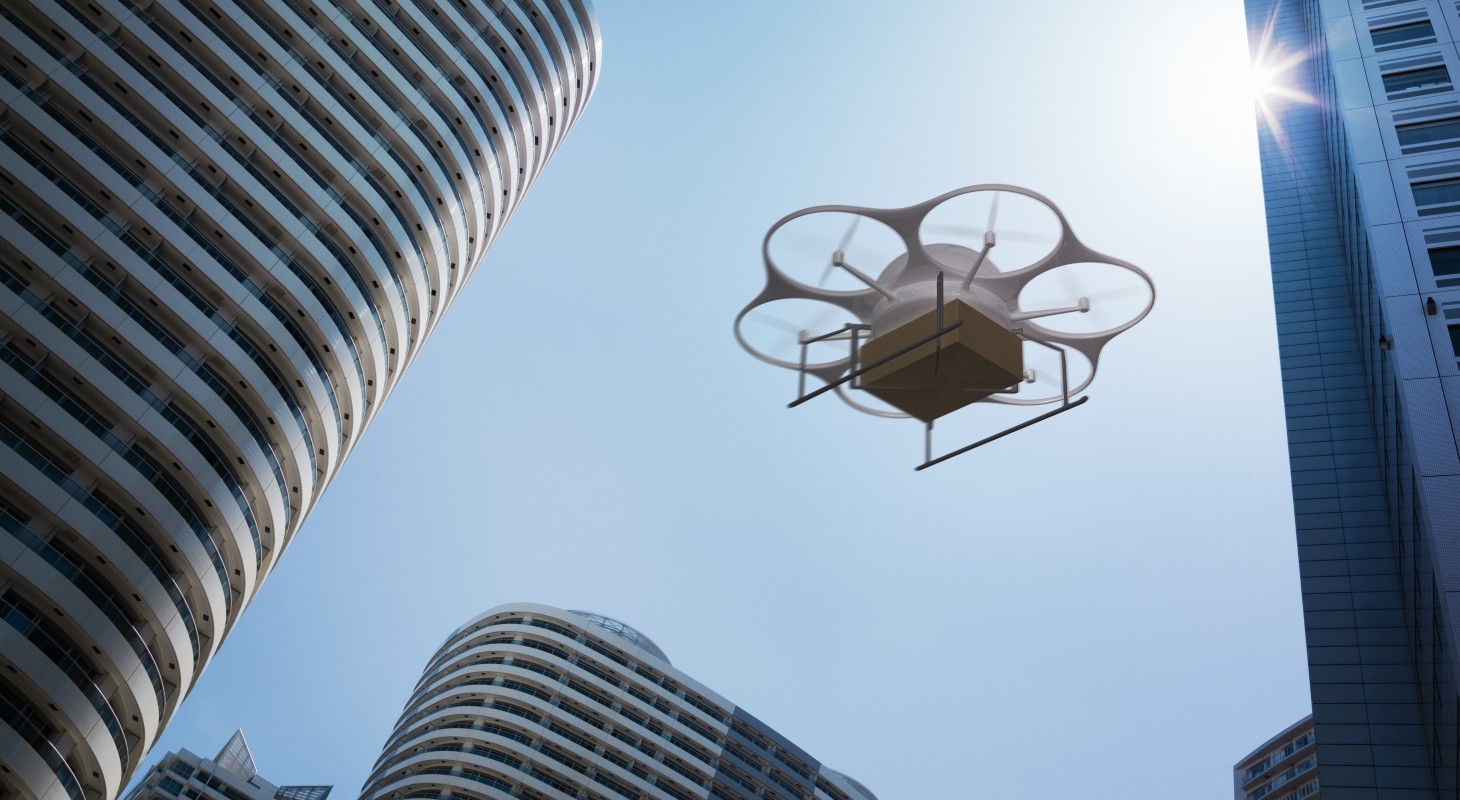 Delivery drone flying above high rise apartments 