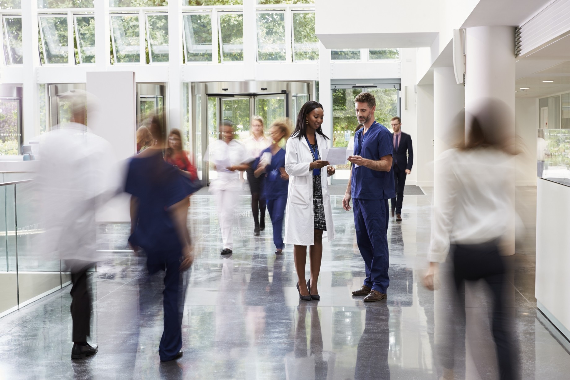 staff in busy lobby area of modern hospital