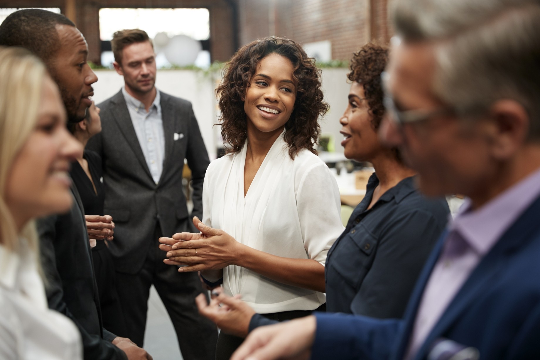 business team standing having informal meeting in modern office