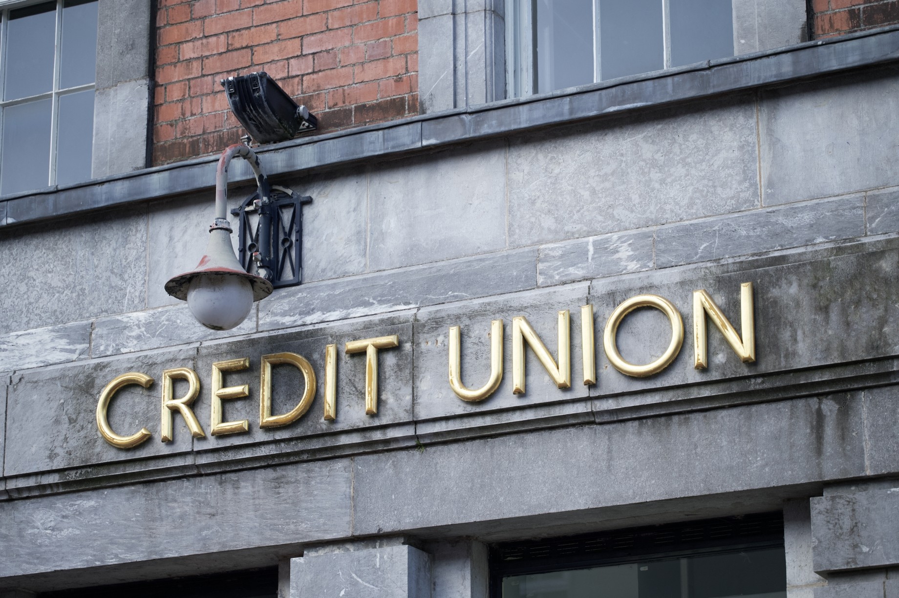 credit sign on stone wall building