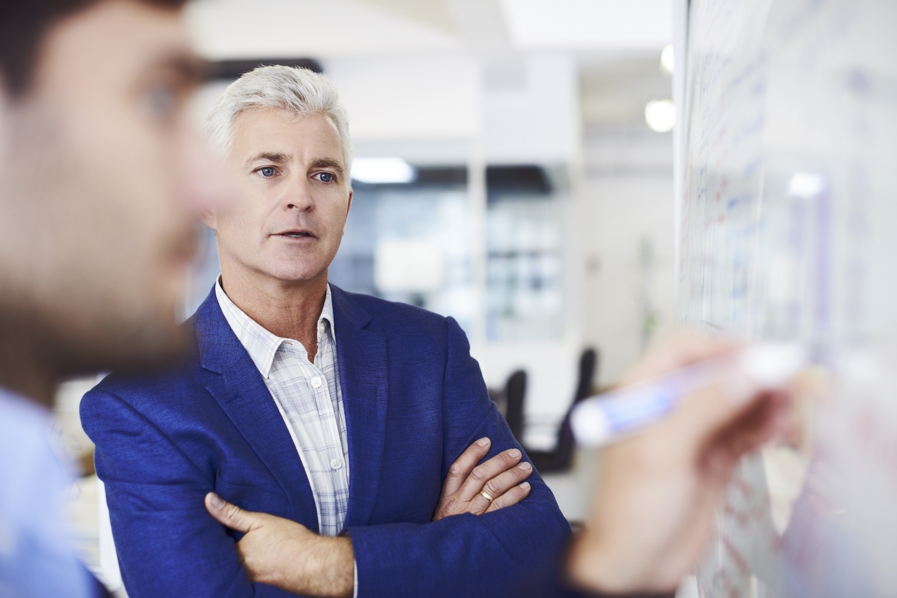 businessman with colleague writing on whiteboard