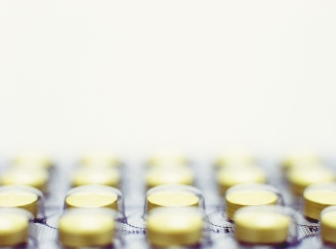 close up of round yellow pills in blister pack