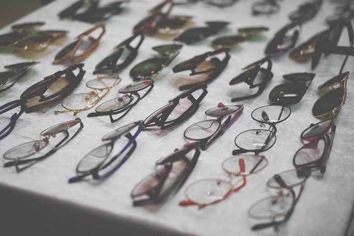 selection of eyeglasses frames on gray table