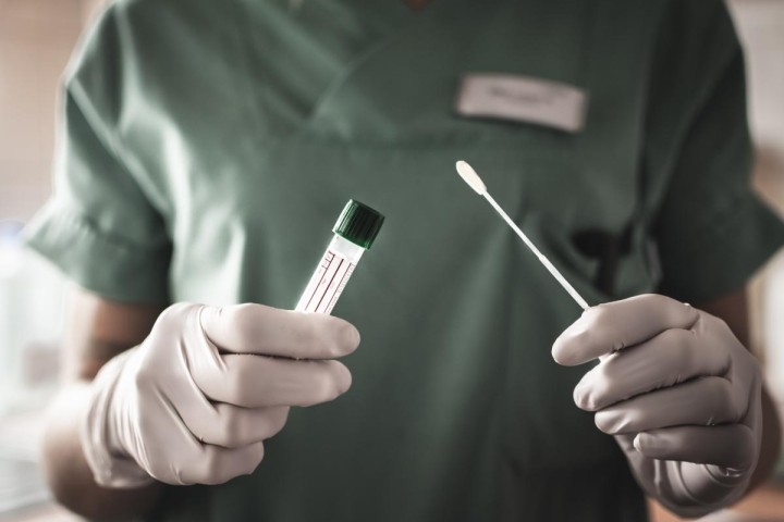 nurse-in-green-scrubs-with-coronavirus-test-swab