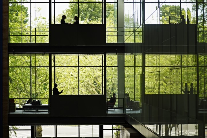 multiple levels in a glass building with executives on various floors