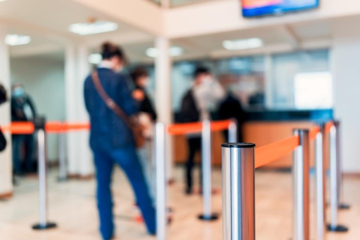 soft focus on people standing in bank teller line