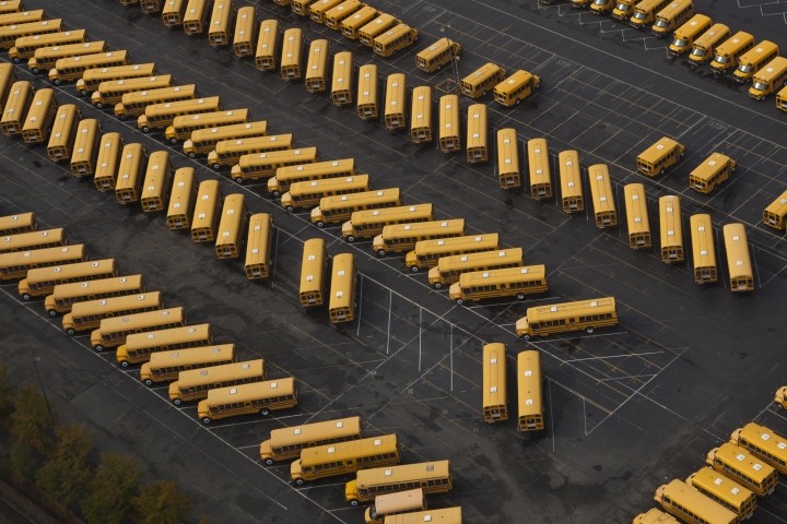 school buses in parking lot view from above