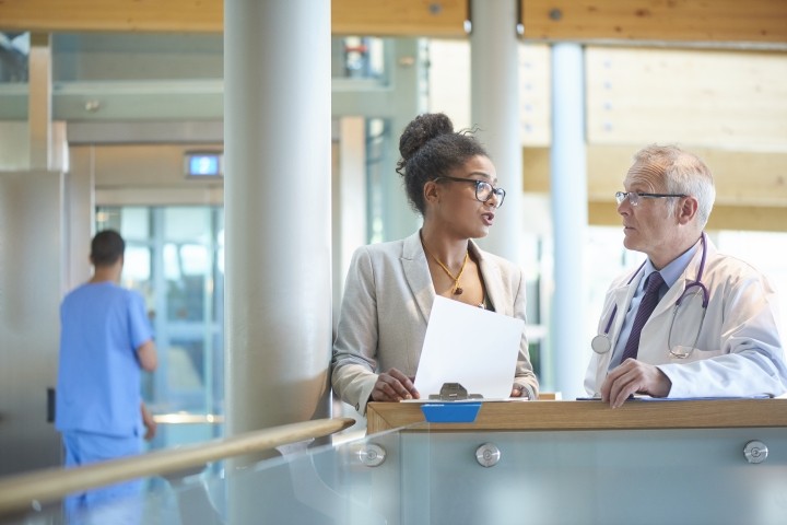 male and female hospital administrators discussing an issue