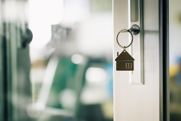 key ring with house charm in door lock