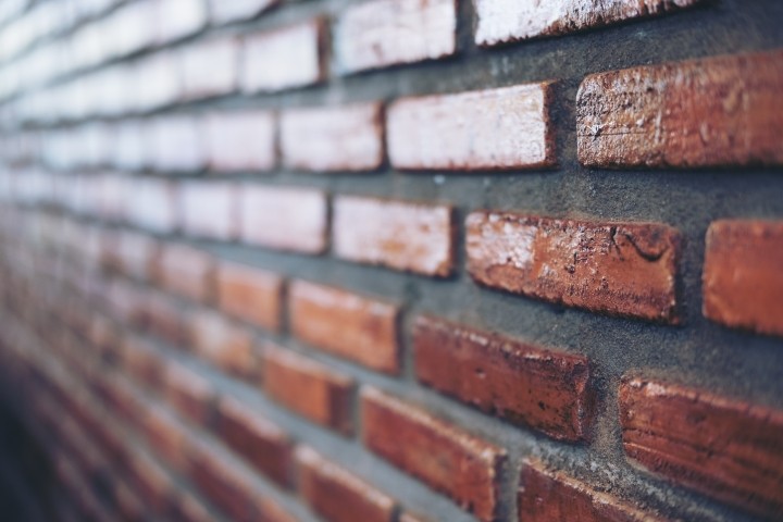 angled closeup view of red brick wall