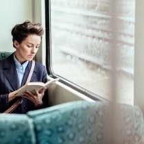 woman on train reading book