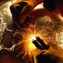 sculptor welding bronze globe