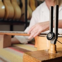 close up of woman tuning guitar