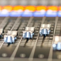 sound mixing board with orange and blue lights