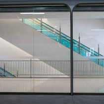 escalators framed with blue glass