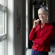 female executive with cropped gray hair in bright red blouse