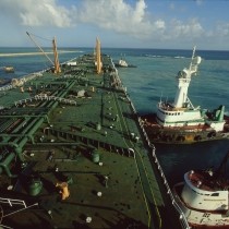 elevated view of oil tanker ship and tugboats