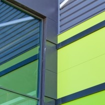 close up of bright blue and lime aluminum facade on industrial building