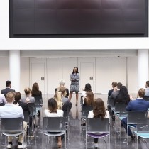 female business leader making presentation in modern office building