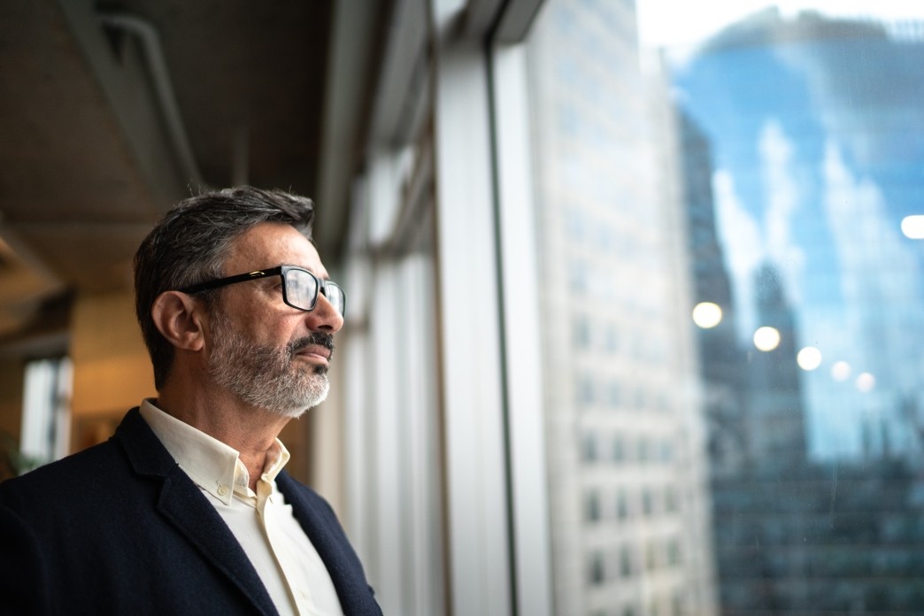 mature businessman looking out of window