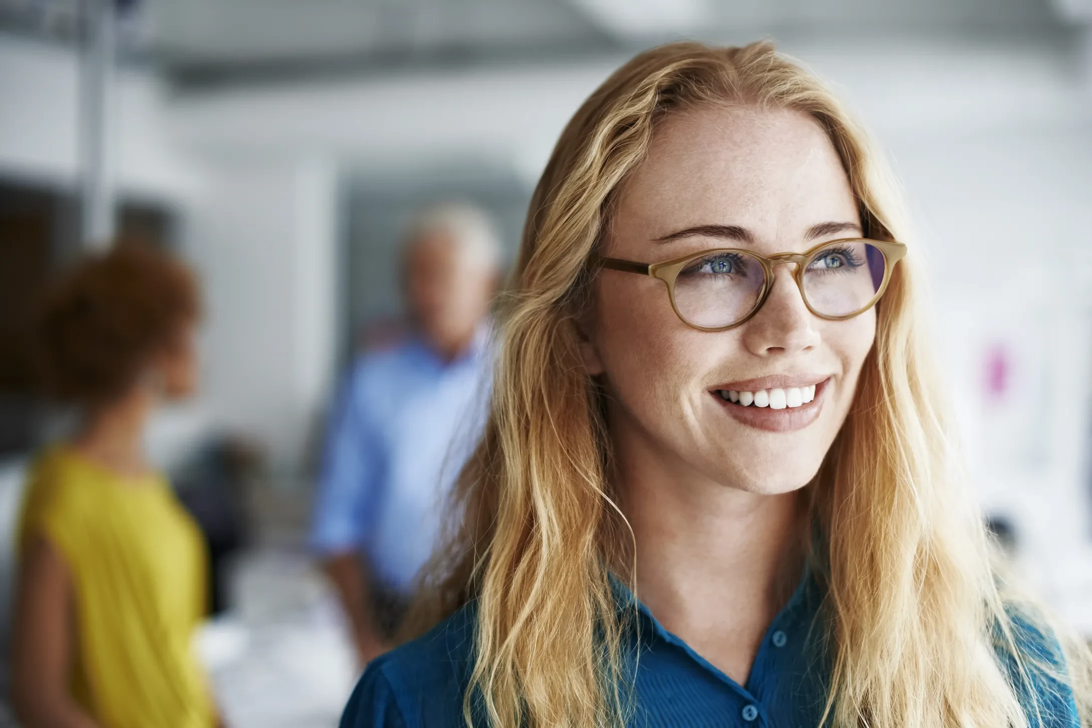 thoughtful businesswoman smiling in office