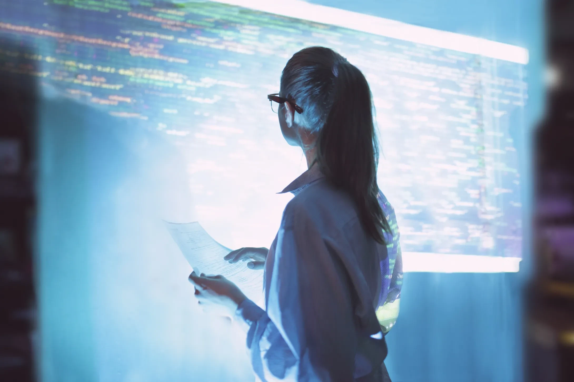 women looking at wall with code